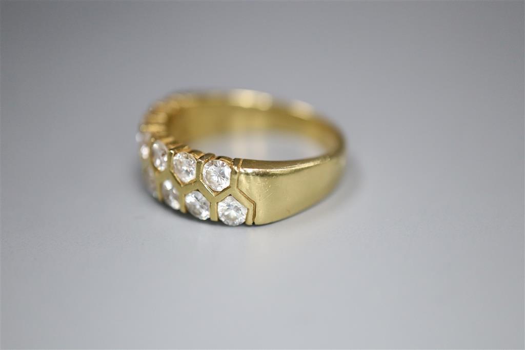 A modern 18ct gold and fifteen stone two row diamond set half hoop ring, size O, gross 6.6 grams.